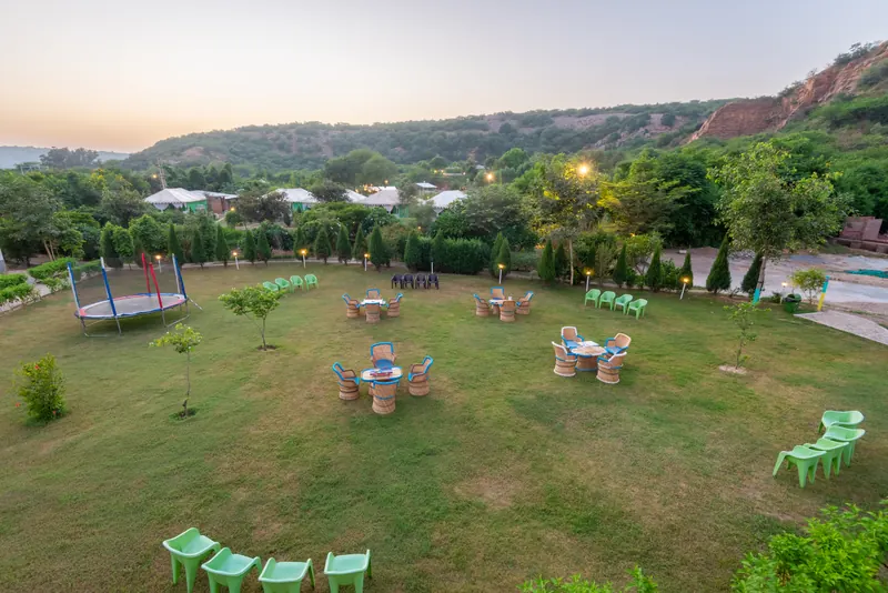 An open garden with seating and hills beyond the retreat