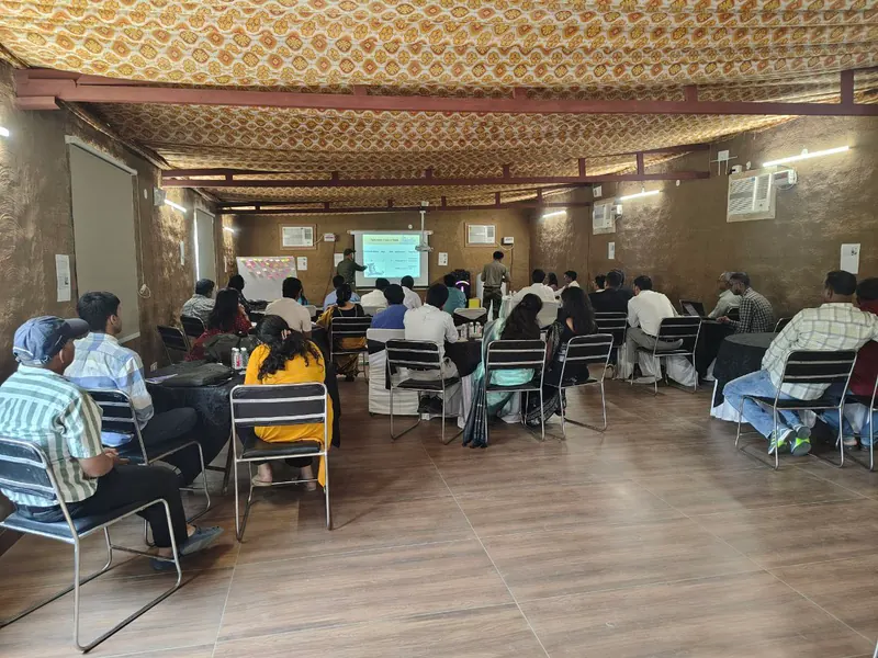 A group attending an indoor session at Farm Aravalia