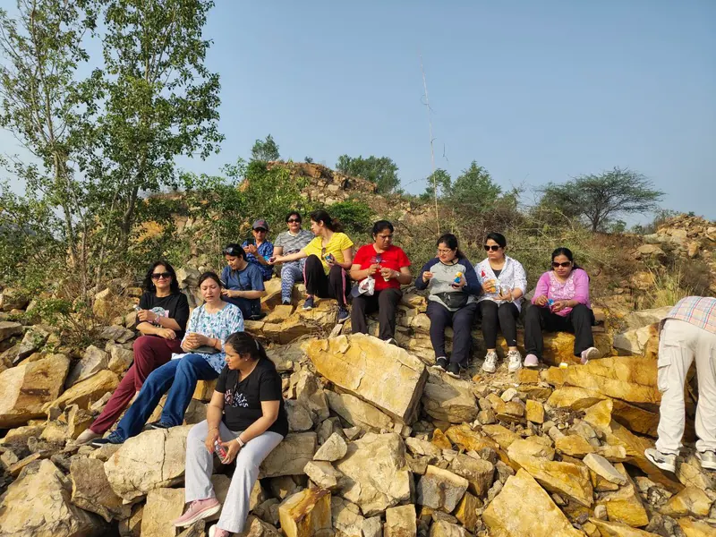 A group exploring the rocky Aravalli landscape near the retreat