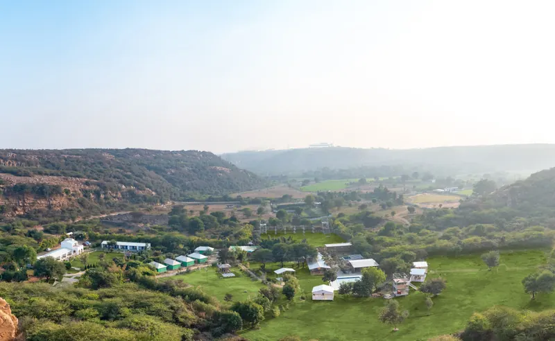A panoramic view across Farm Aravalia and the surrounding Mangar valley