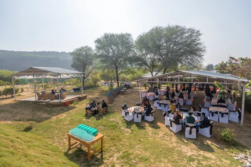 A group gathering in the outdoor setting at Farm Aravalia