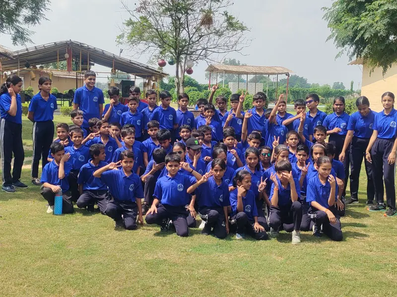 A school group gathered on the lawns during a visit to Farm Aravalia